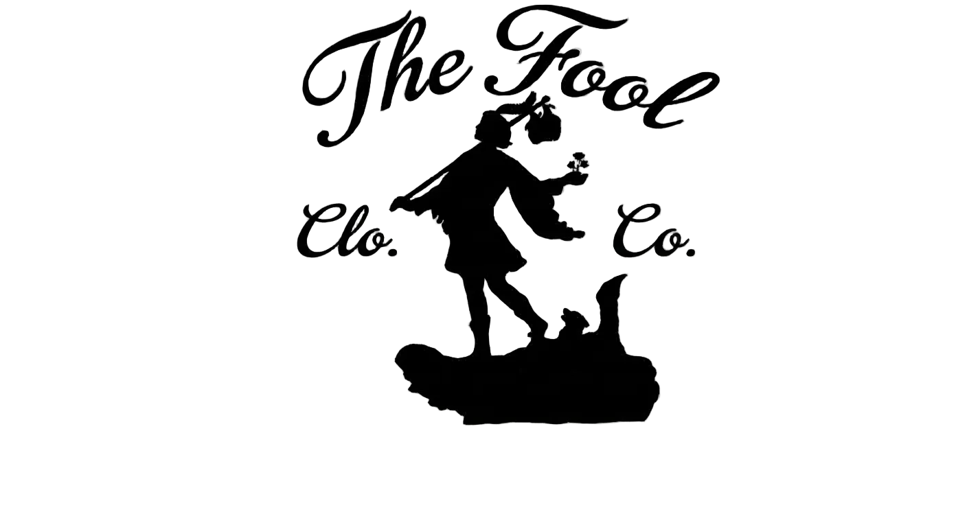 Black silhouette of a character on a rock with 'The Fool Co.' text on a transparent background